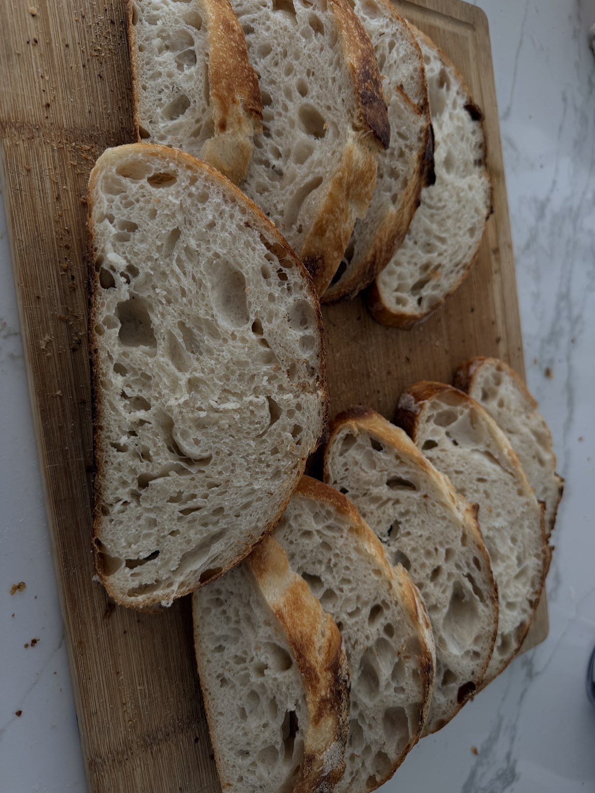 Sliced sourdough showing an airy crumb on a cutting board
