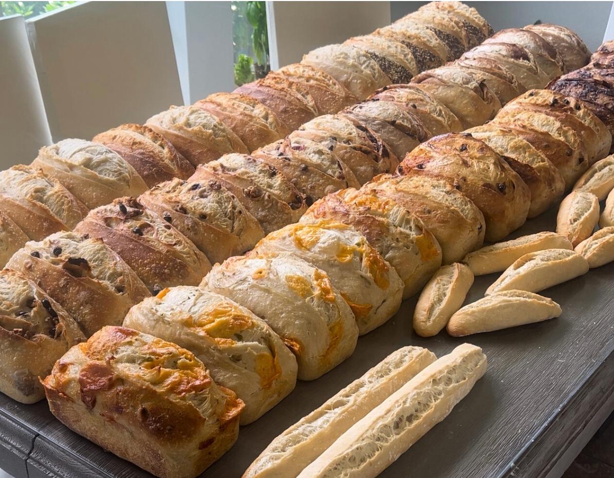 A table filled with freshly baked sourdough loaves